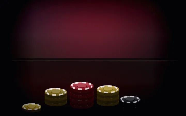 Several stacks of casino chips at different heights on a dark table