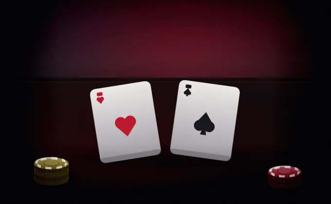 Two playing cards on dark felt beside a stack of gold chips