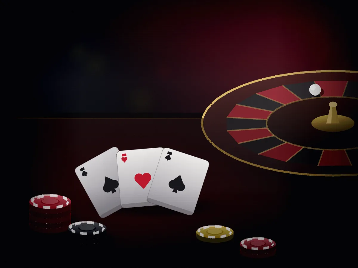Casino table in black and red with playing cards, chips and a roulette wheel under soft lighting